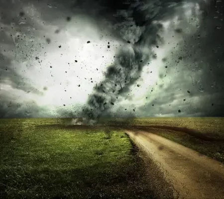 tornado carving a disastrous path in a field