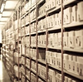Scanning Boxes On Shelves scanning hallway of shelves with boxes of documents