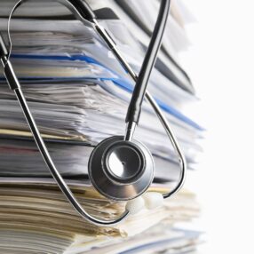 medical-scanning scanning a stack of medical records with stethoscope